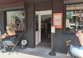 Image of a people sitting outside a cafe