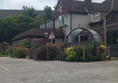 View of front and car park with one disabled parking space.