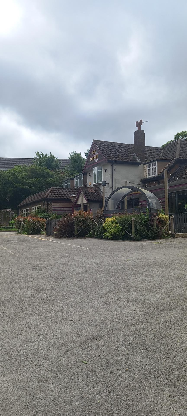 View of front and car park with one disabled parking space.