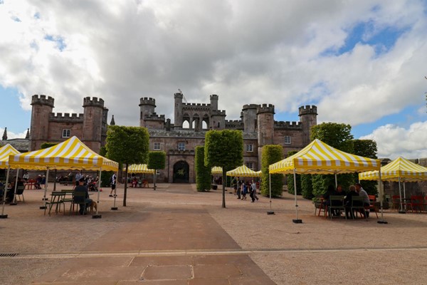 Courtyard area with picnic tables and gazebos providing shade.