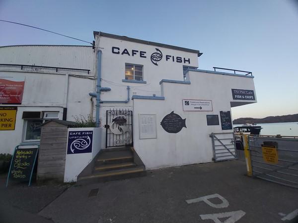 Image of a white building with a sign on it