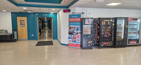 Image of DISC foyer with view to the hallway that leads to the main sports hall. Vending machines are also present.