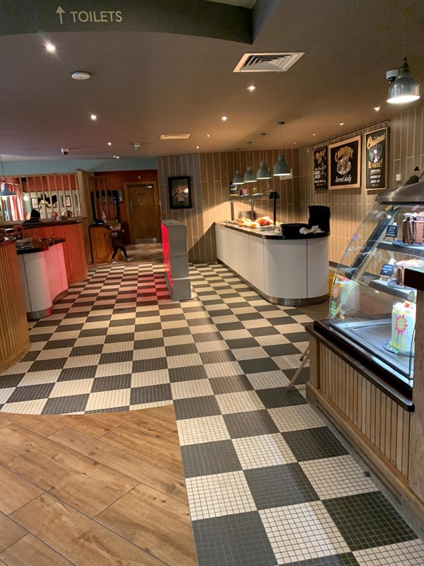 Picture of the pub floor and the toilet sign