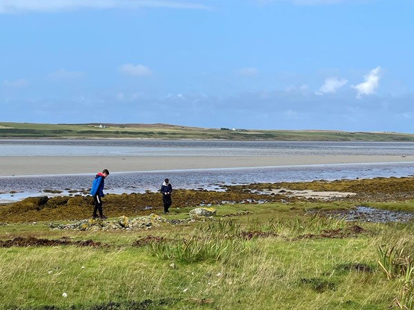 Image of two people near a beach