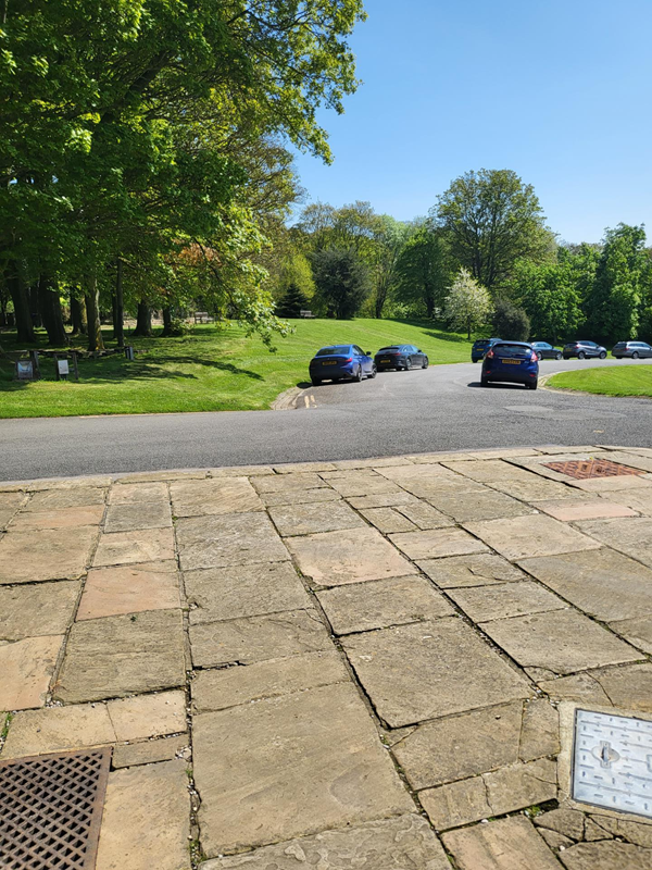 Image of a road with cars parked on it