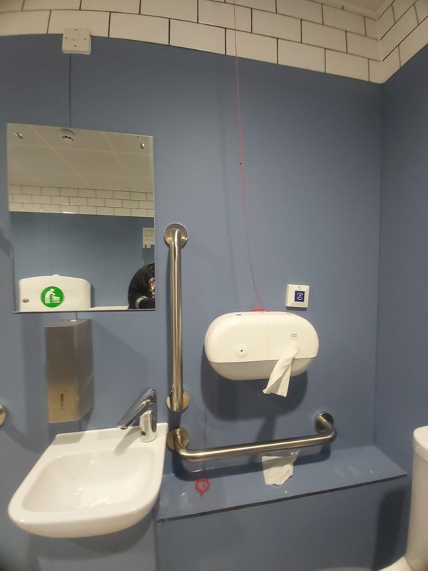 Image of a bathroom with a hand wash sink and a mirror