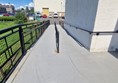 Image of a ramp with a railing leading up from the carpark