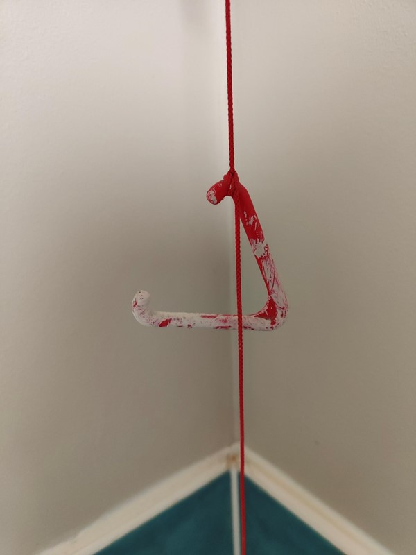 red emergency cord covered in paint