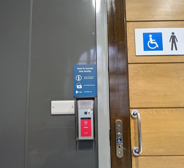 Image of signs at the disabled toilet showing how to get the RADAR key.