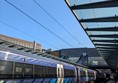 Image of the train platform, a blue Scotrail train is on the tracks.