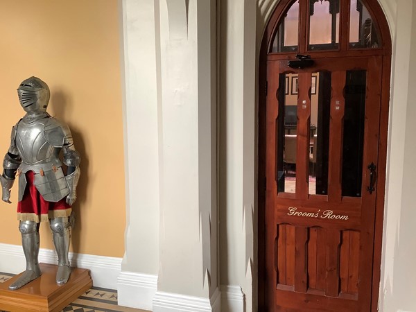 Picture of a suit of armour by a door