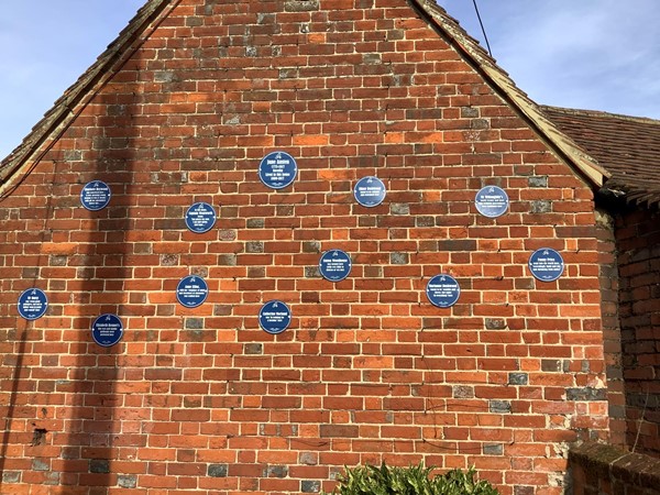 Lots of blue plaques on a wall