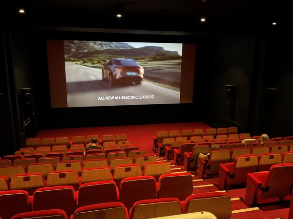 which is a very nice small auditorium brightly decorated with warm coloured seating