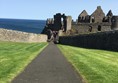 View of castle from entrance showing decline onto bridge all level access