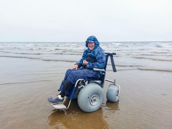 A person in a wheelchair on a beach