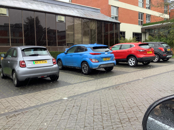 Image of cars parked outside a hotel