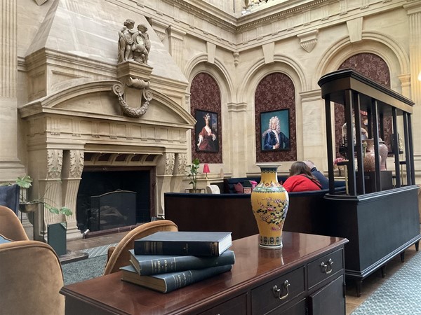 Image of a room with a fireplace and books on a table