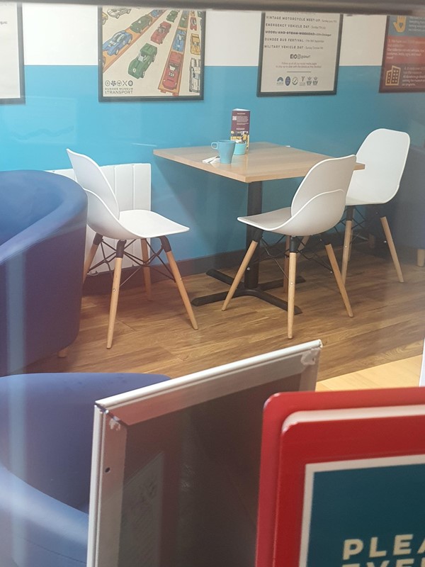 Image of one of the cafe tables through the window.