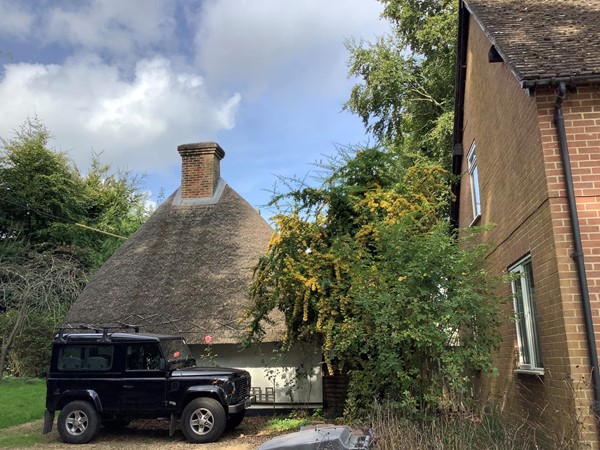 Black jeep in front of a housr