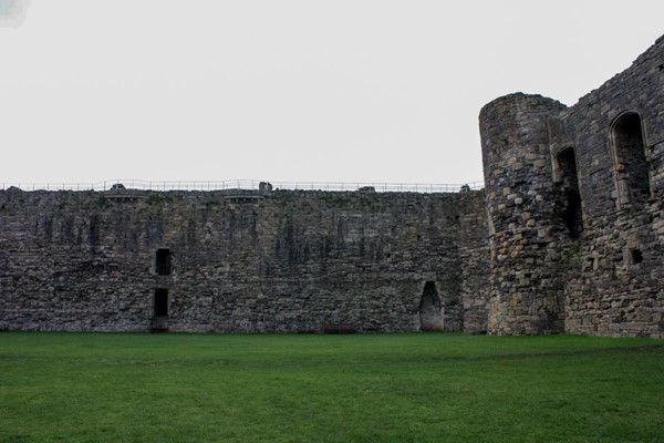 Large grassed area inside the castle walls.