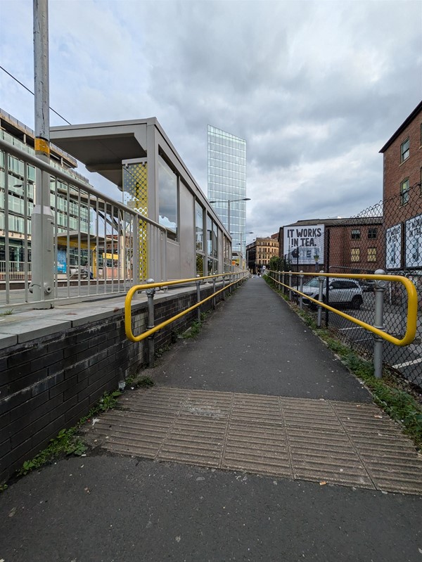 Image of access ramp with yellow grab rails