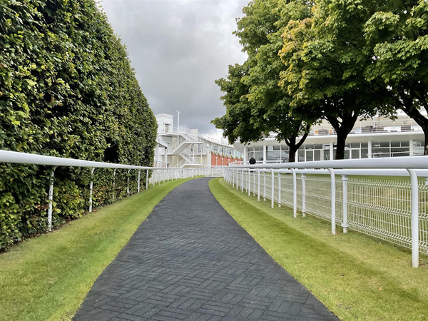 Image of a path through a white fence