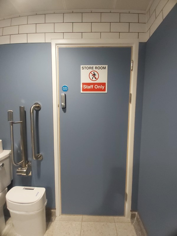 Image of a bathroom with a sign and toilet