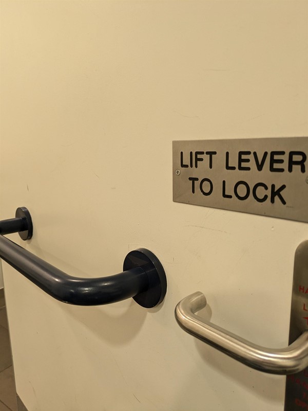 Image of  grab rail and level lock on the accessible toilet door