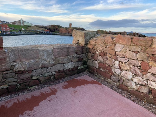 Flat path and stone wall with a view over harbour