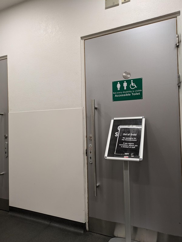 Image of door to accessible toilet with out of order sign