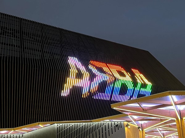 Outside the arena. The word ABBA is lit up in pride flag colours.