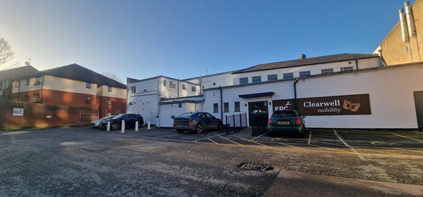 Image of a building with cars parked in front of it