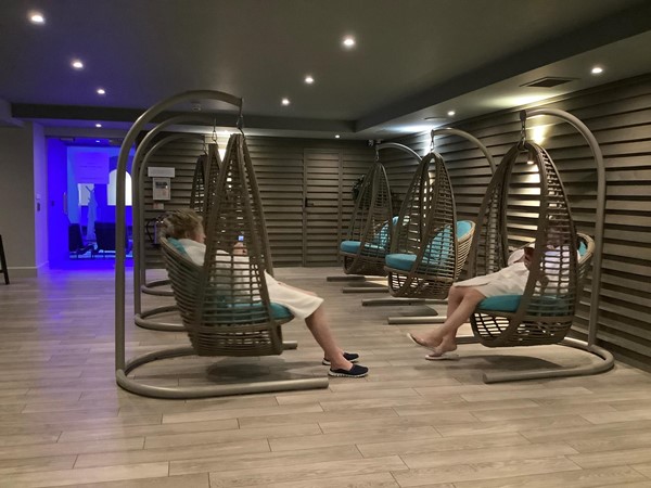 Picture of people in swinging wicker seats