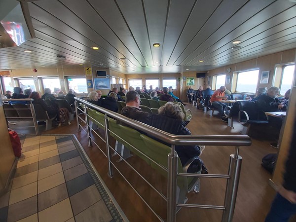 Image of a group of people sitting in a ferry