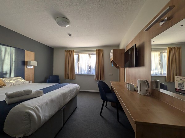 Image of bed and desk in the accessible hotel room