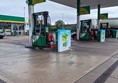 Image of a petrol station with a green and white gas station