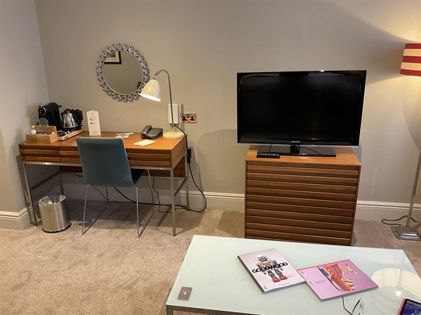 Image of a room with a television and a desk