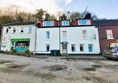 Image of front of Harbour Guest House, a white building, three stories high