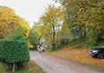 Road down from the pitches to the facilitites block which is where the buildings are on the right at the bottom of the hill. The hill is steeper than it looks in the picture.