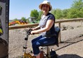 Using a scooter at Diggerland Kent with two rides in the background