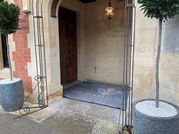 The front door entrance is very close to parking bays, rather dull and unattractive with a large original wooden door, but of note is the ornate lamp above your head. It had to be completely refurbished, the many layers of old paint had to be sand blasted off to reveal the original copper and brass metal work. The metal was lacquered, and the sand blasted steel work was zinc coated and then painted black. The restored lamp was then re-installed to offer a light glow as you enter the Hall.