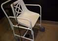 Shower chair that can be removed if non-disabled people in room. Note 4 wheels and arms that can be detached.