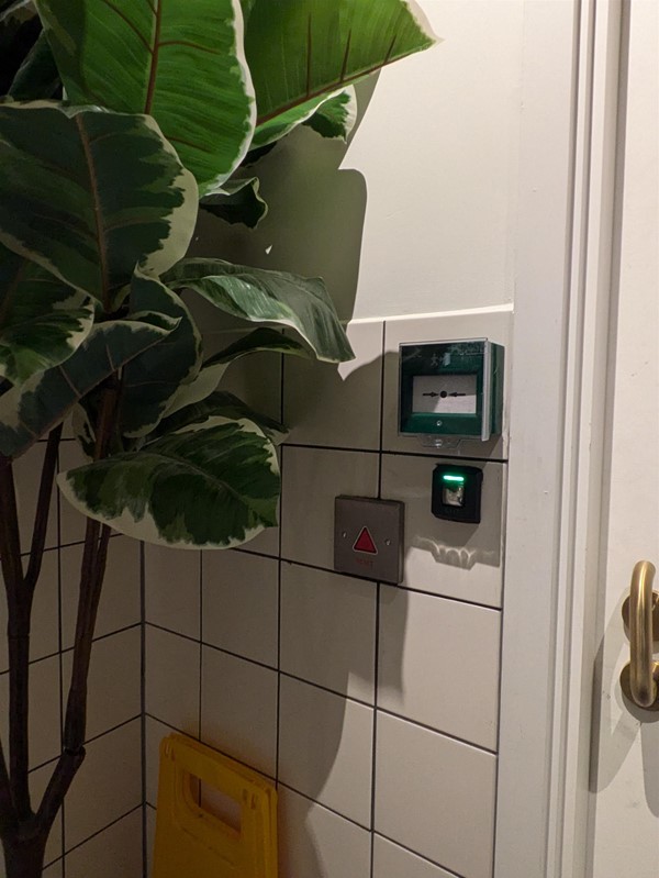 Image of button to secure accessible toilet