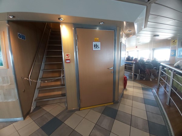 Image of a door with stairs and people sitting on the floor