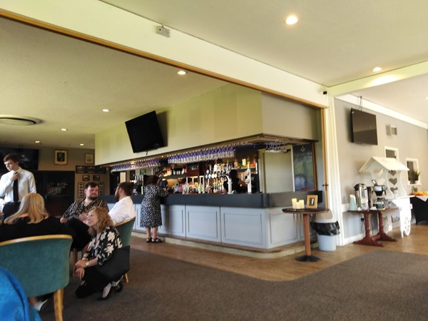 Image of a group of people sitting at a bar