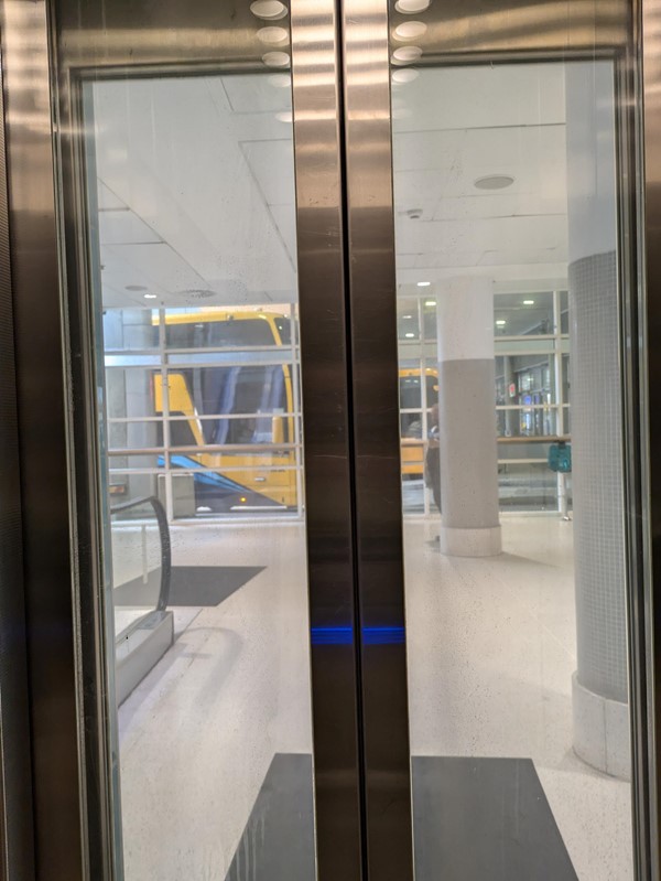 Image of lift doors, opening to the bus station