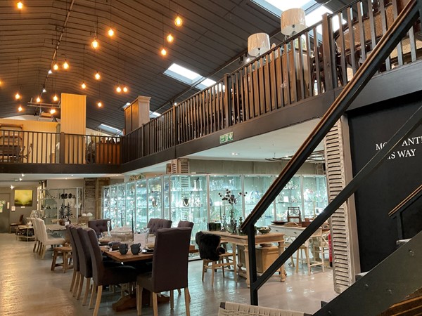 Image of a room with a staircase and a table and chairs