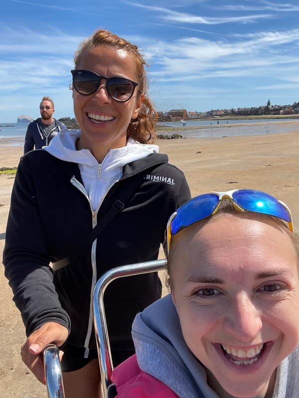 Two people smiling at the camera on North Berwick beach