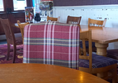 View of interior and door to children's play area from a round wheelchair accessible table.