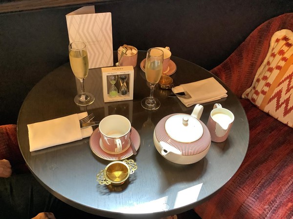 A table with a tea pot and tea cup on it